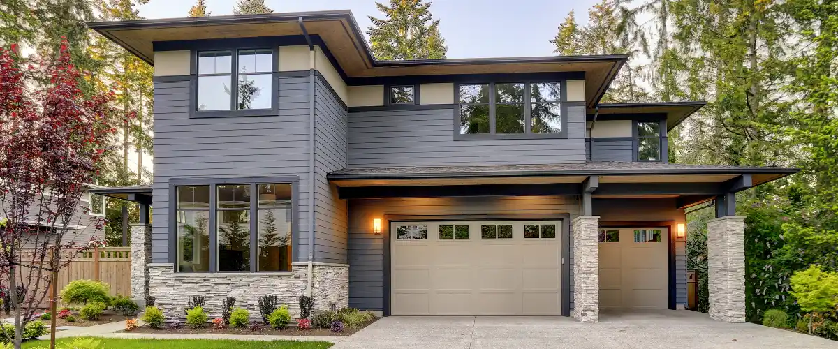 a modern-style two-story house featuring dark toned horizontal siding
