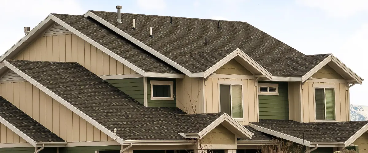 a residential building featuring a complex arrangement of gable roofs