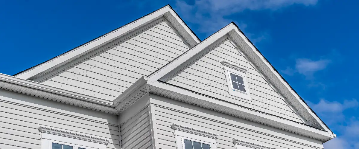 a residential building with white vinyl siding