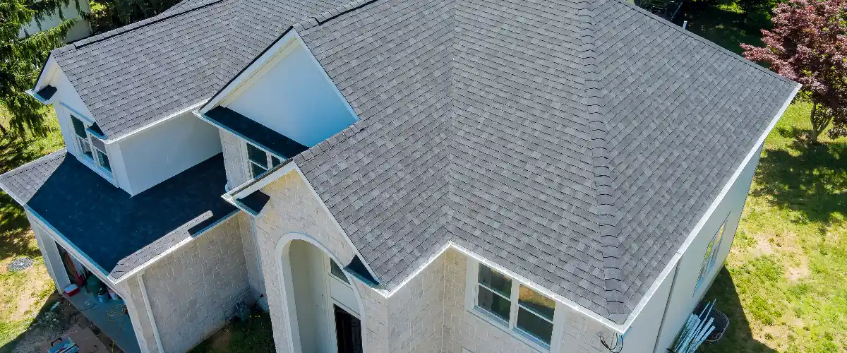 a two story house with a shingle roof