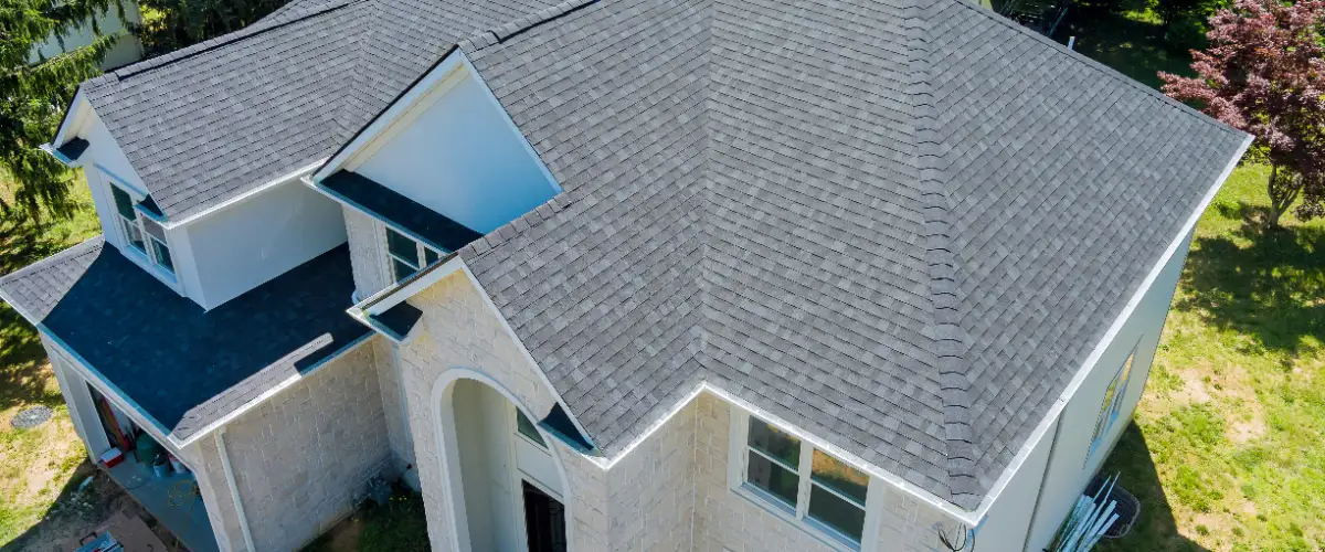 a residential house with a new asphalt shingle roof