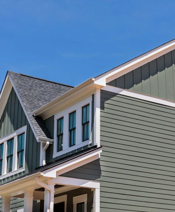 Professional siding installation in Colts Neck, NJ, featuring olive green horizontal lap siding and white window trim.
