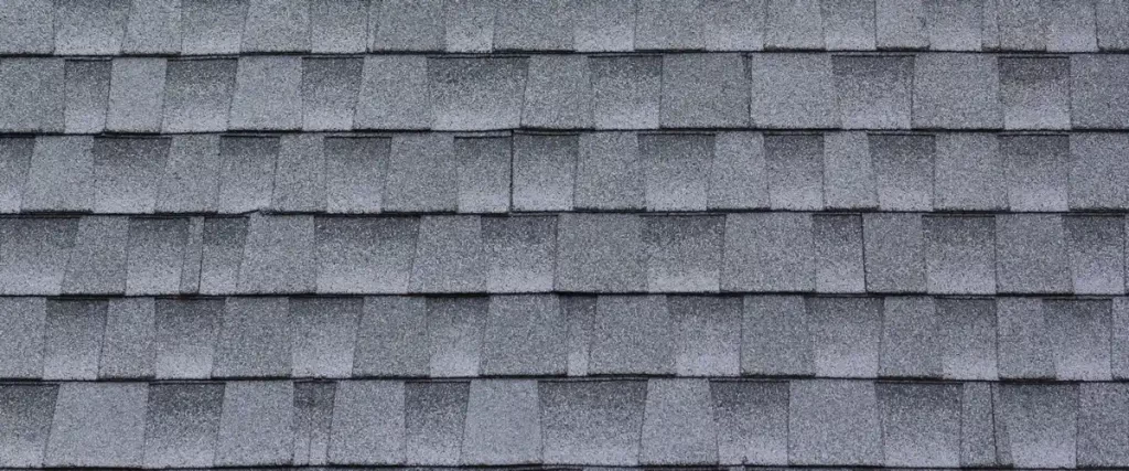 A repetitive and clean pattern of architectural gray roof shingles providing a waterproof barrier for a home.