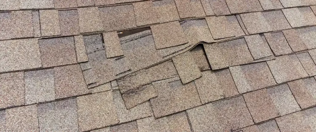 Asphalt shingles sliding out of alignment as a direct result of poor installation and improper nailing.