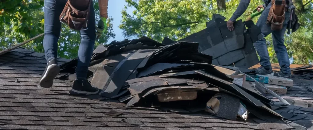 A magnifying glass over an insurance coverage document highlighting roof repairs.