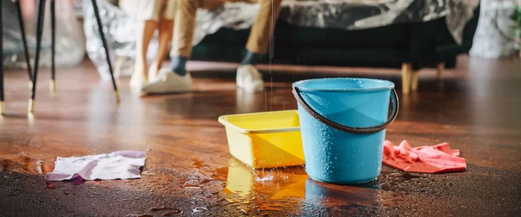 Close-up view of interior ceiling damage caused by active roof leaks.