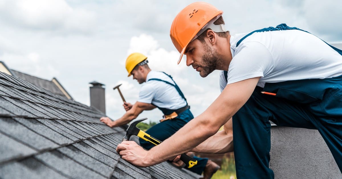 Professional contractor performing high-quality roof repair and full shingle replacement on a residential home.