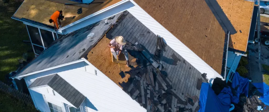 Professional roofing team performing a full roof replacement on a residential home.