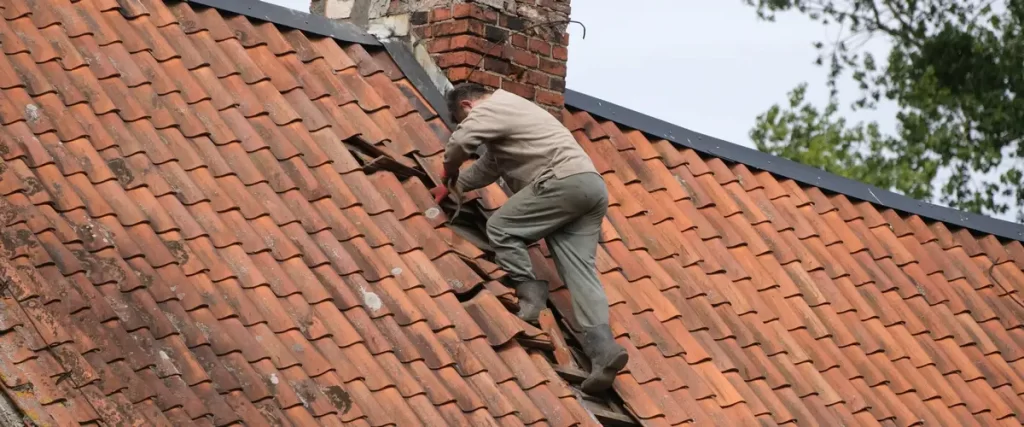 A clean wide-angle view of a recently finished gray slate tile roof on a suburban family home.